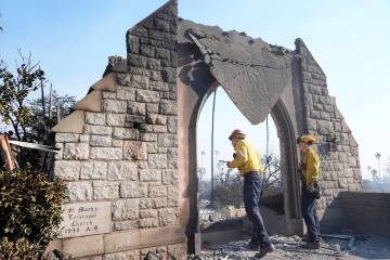 Firefighters study damage at St. Mark's Episcopal Church after it was destroyed by the Eaton Fi ...