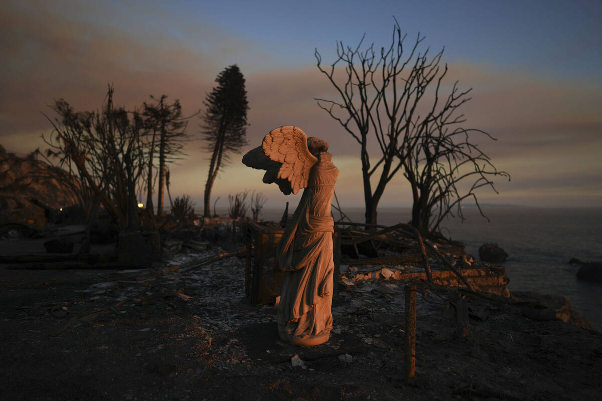 A statue stands amidst damage from the Palisades Fire on Friday, Jan. 10, 2025, in Malibu, Cali ...