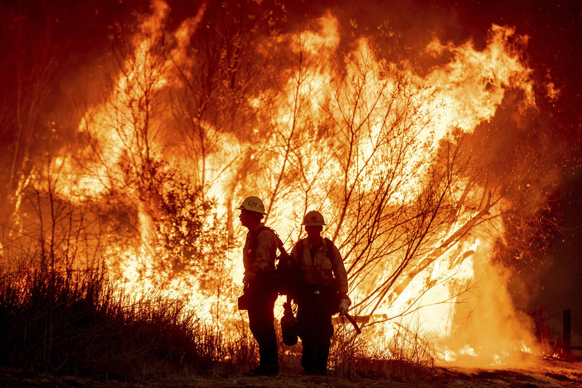 Fire crews battle the Kenneth Fire in the West Hills section of Los Angeles, Thursday, Jan. 9, ...