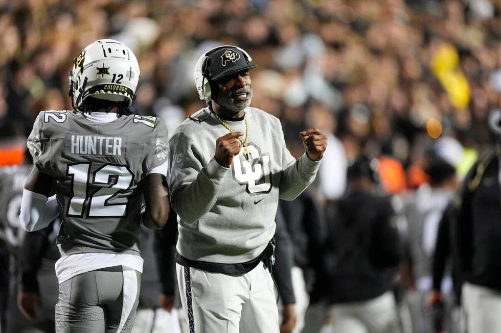 Colorado wide receiver Travis Hunter (12) and Colorado head coach Deion Sanders in the first ha ...