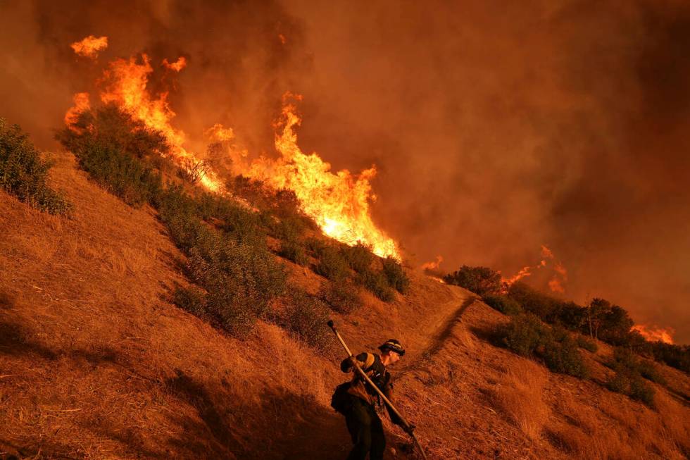 A firefighter battles the Palisades Fire in Mandeville Canyon on Saturday, Jan. 11, 2025, in Lo ...