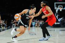 Aces guard Kelsey Plum (10) moves the ball towards the hoop as Atlanta Dream guard Allisha Gray ...