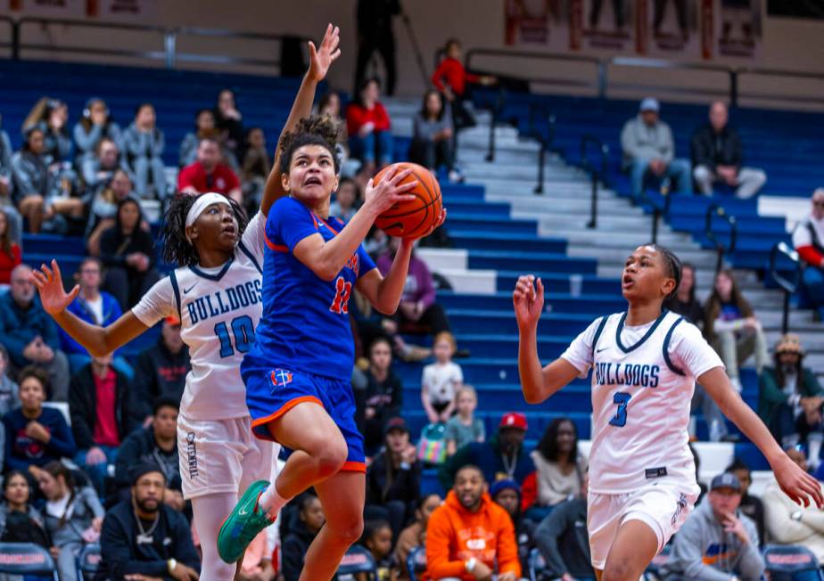 Bishop Gorman's guard Aaliah Spaight (10) looks to score past Centennial guard Sanai Branch (10 ...