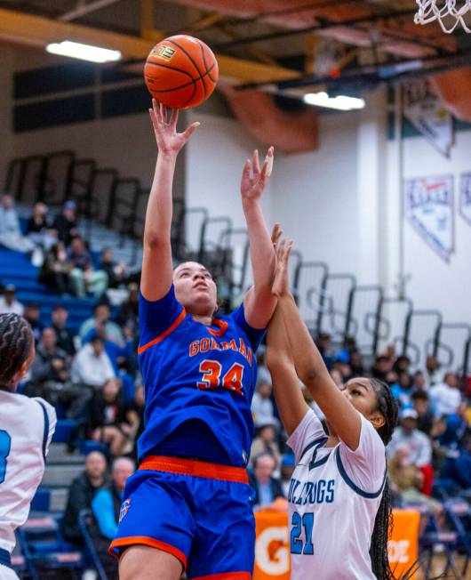 Bishop Gorman guard Savannah Searcy (34) gets off a shot over Centennial guard Aly Brown (21) d ...