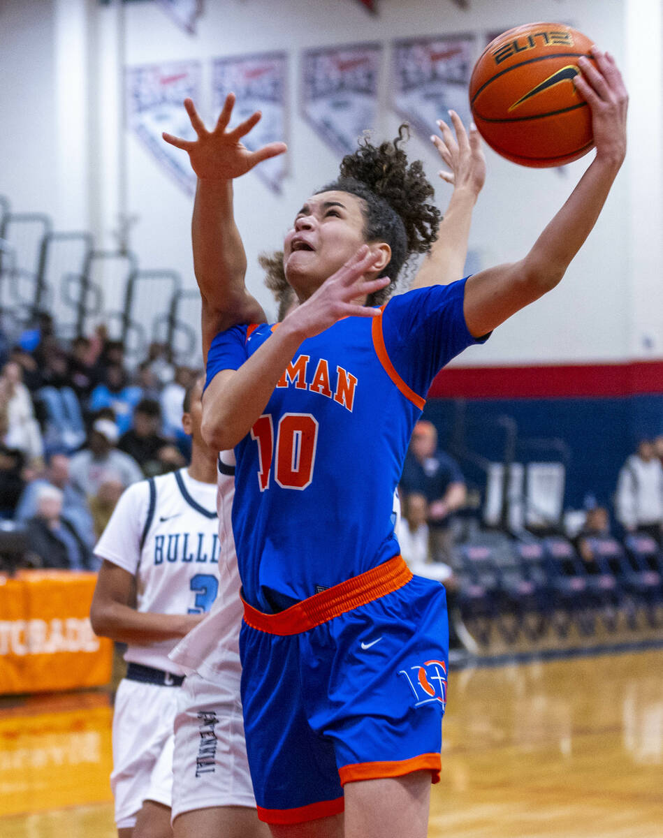 Bishop Gorman guard Aaliah Spaight (10) gets to the net ahead of the Centennial defense during ...