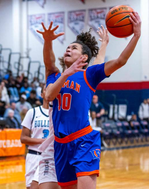 Bishop Gorman guard Aaliah Spaight (10) gets to the net ahead of the Centennial defense during ...