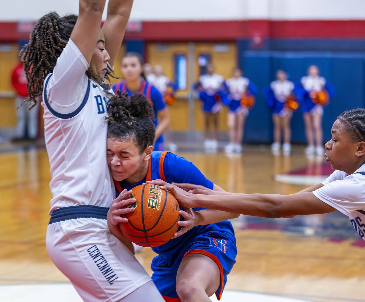 Bishop Gorman guard Aaliah Spaight (10) crashes into Centennial forward Ayla Williams (12) whil ...