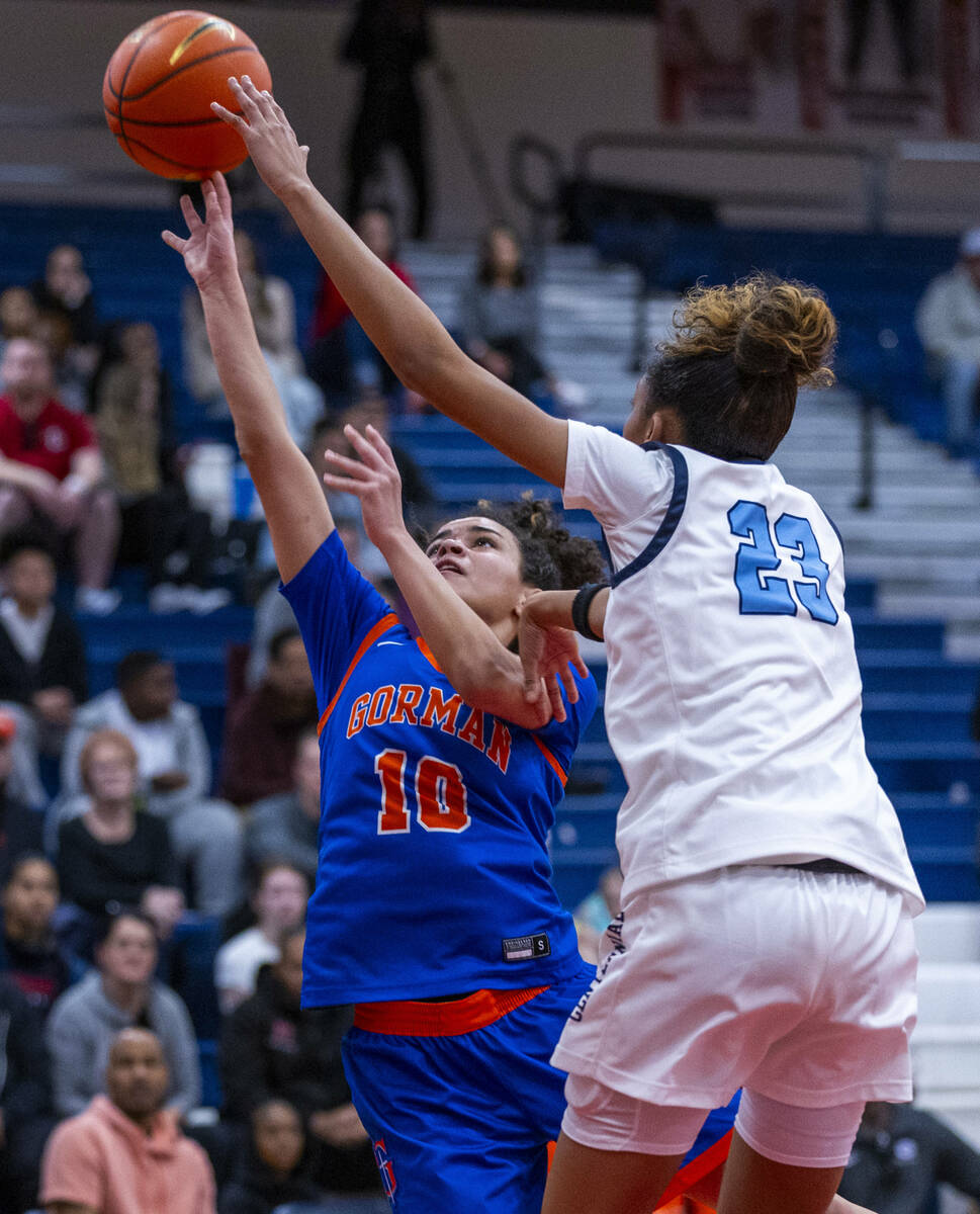 Bishop Gorman's guard Aaliah Spaight (10) has a shot blocked by Centennial forward Damoni Poole ...