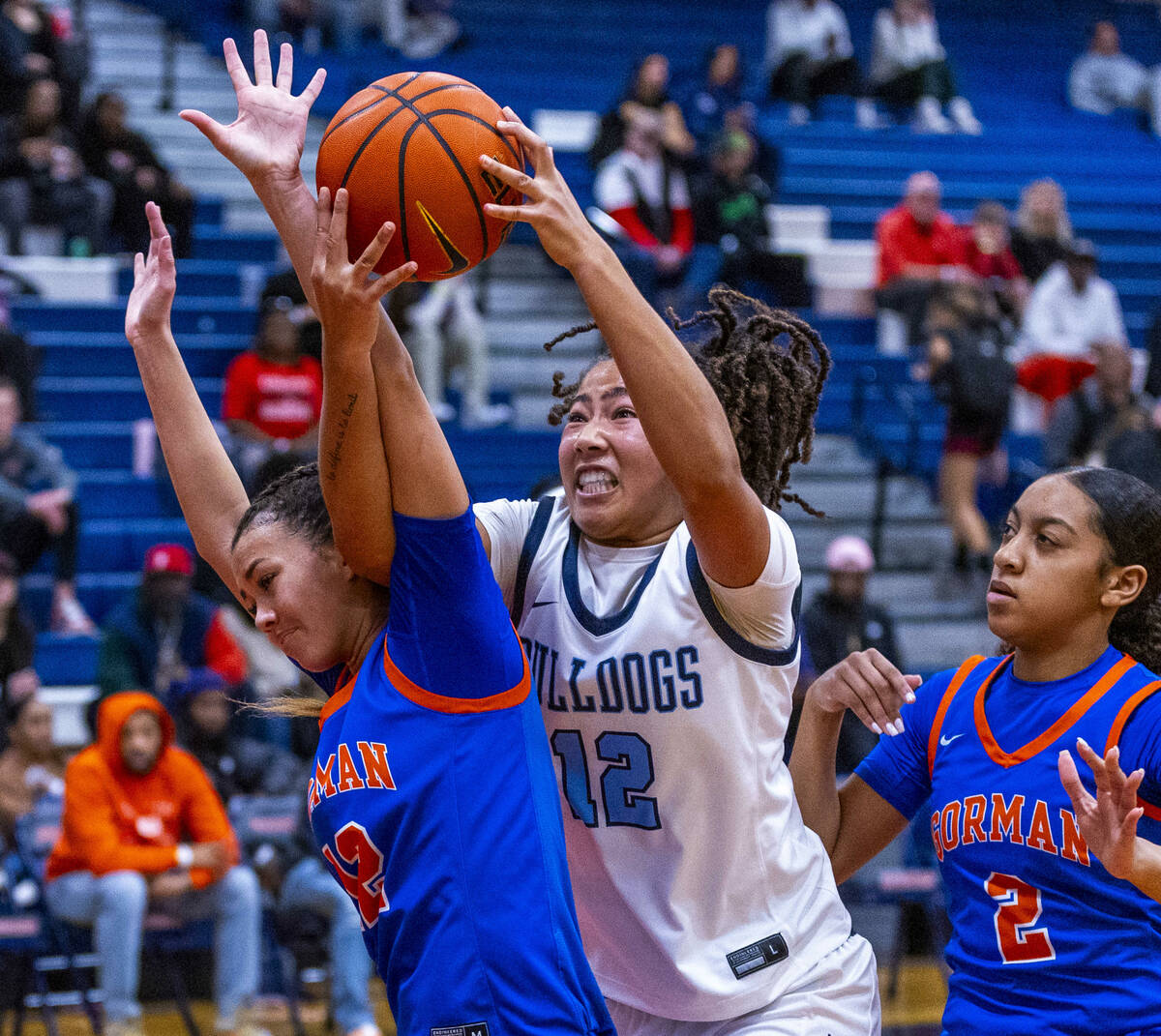 Centennial's forward Ayla Williams (12) grabs a rebound against Bishop Gorman guard Addysen Car ...