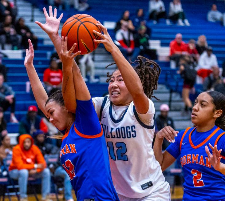 Centennial's forward Ayla Williams (12) grabs a rebound against Bishop Gorman guard Addysen Car ...