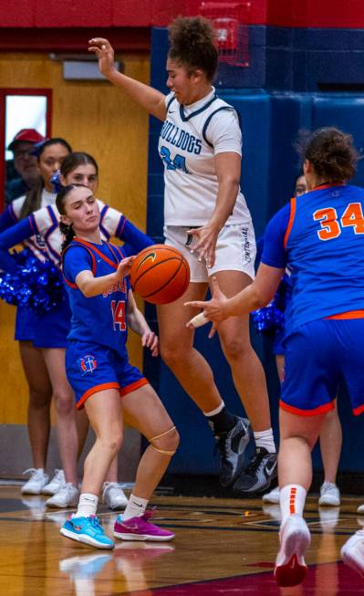 Bishop Gorman guard Kenzee Holton (14) gets off a pass as Centennial forward Nation Williams (2 ...