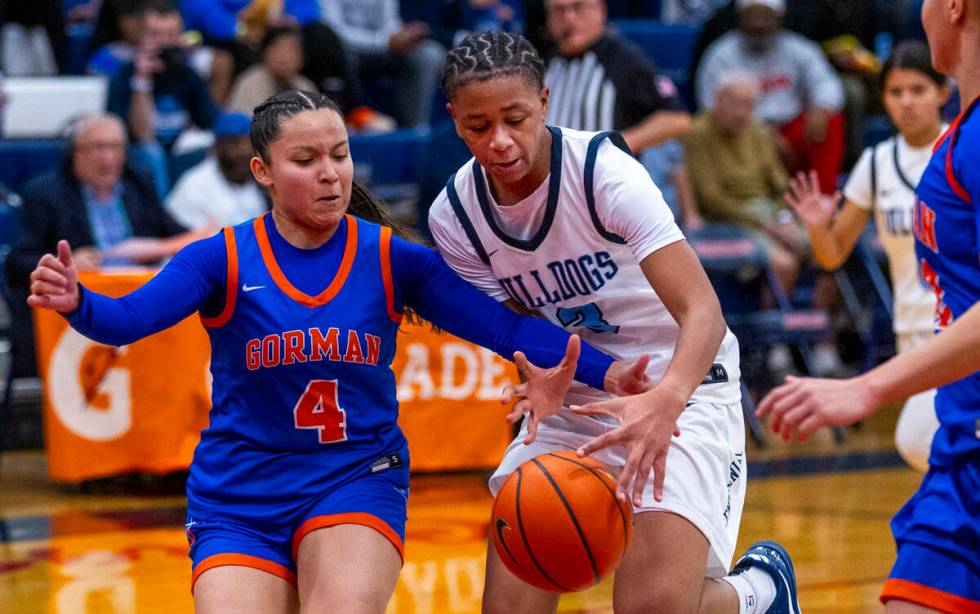 Bishop Gorman guard Anna Barragan (4) works to steal the ball from Centennial guard D'Arrah Mit ...