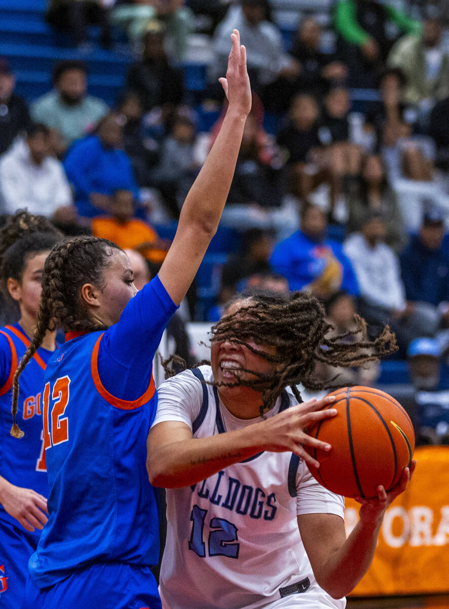 Centennial's forward Ayla Williams (12) grabs a rebound against Bishop Gorman guard Addysen Car ...