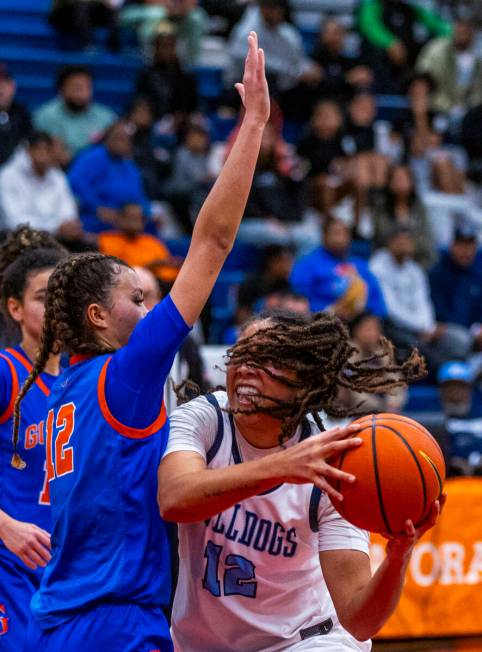 Centennial's forward Ayla Williams (12) grabs a rebound against Bishop Gorman guard Addysen Car ...