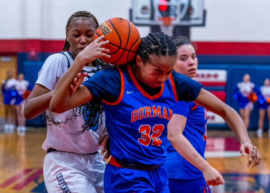 Bishop Gorman center Aubrey Johnson (32) has a ball bounce off her shoulder as Centennial forwa ...