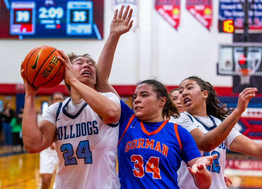 Centennial forward Nation Williams (24) takes an elbow under the basket by Bishop Gorman guard ...