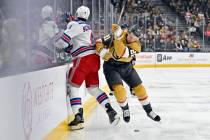 Vegas Golden Knights center Brett Howden (21) checks New York Rangers defenseman Braden Schneid ...