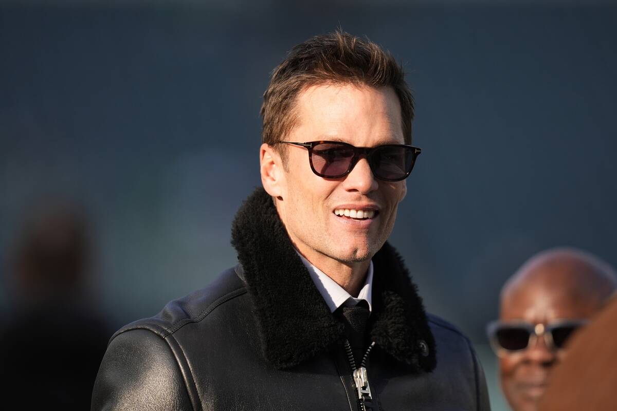 Tom Brady watches warm ups before an NFL wild-card playoff football game between the Philadelph ...