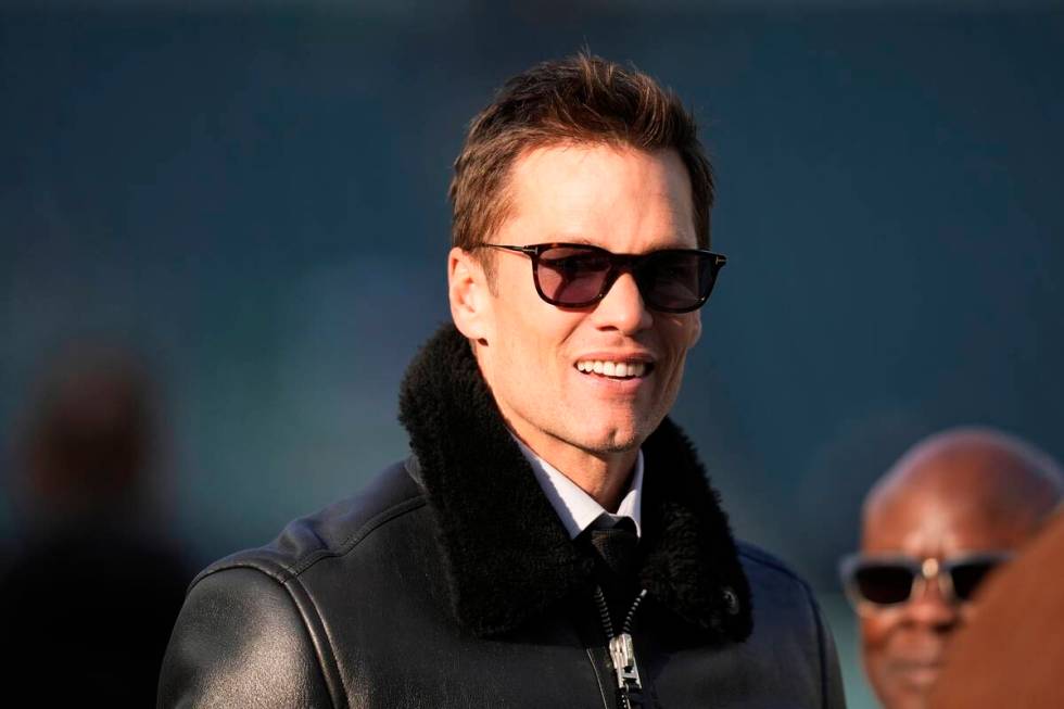 Tom Brady watches warm ups before an NFL wild-card playoff football game between the Philadelph ...