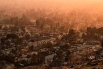 Smoke lingers over a neighborhood devastated by the Eaton Fire, Thursday, Jan. 9, 2025, in Alta ...