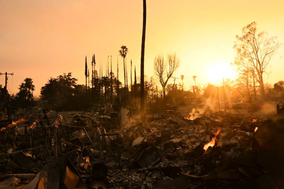 The sun sets over damage from the Eaton Fire, Thursday, Jan. 9, 2025, in Altadena, Calif. (AP P ...