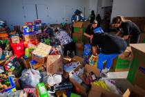 Las Vegas Aces staff sort through donations to send to victims of the Los Angeles wildfires in ...