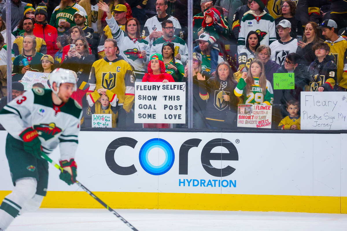 Fans hold up posters for Minnesota Wild goaltender Marc-Andre Fleury (out of frame) before an N ...