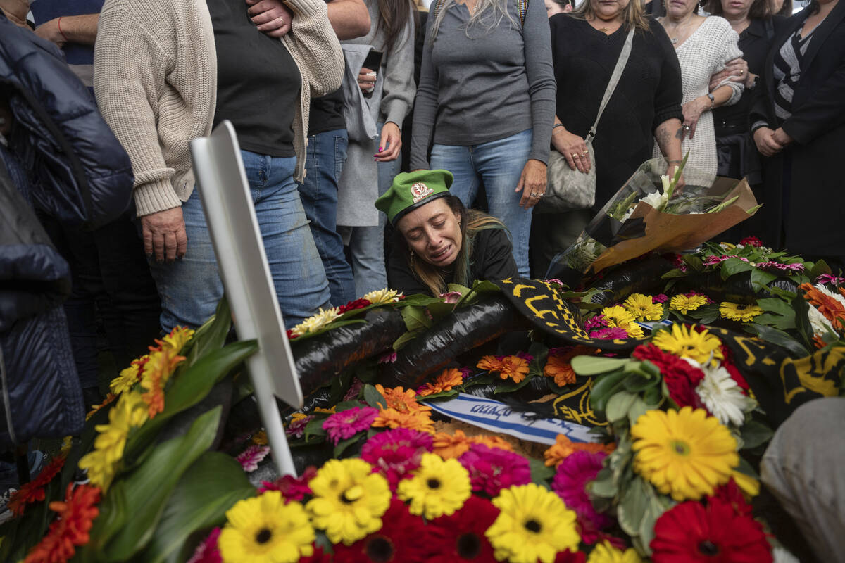 Gali, whose son, Sgt. Yahav Maayan, was killed in combat in the Gaza Strip, reacts next to his ...