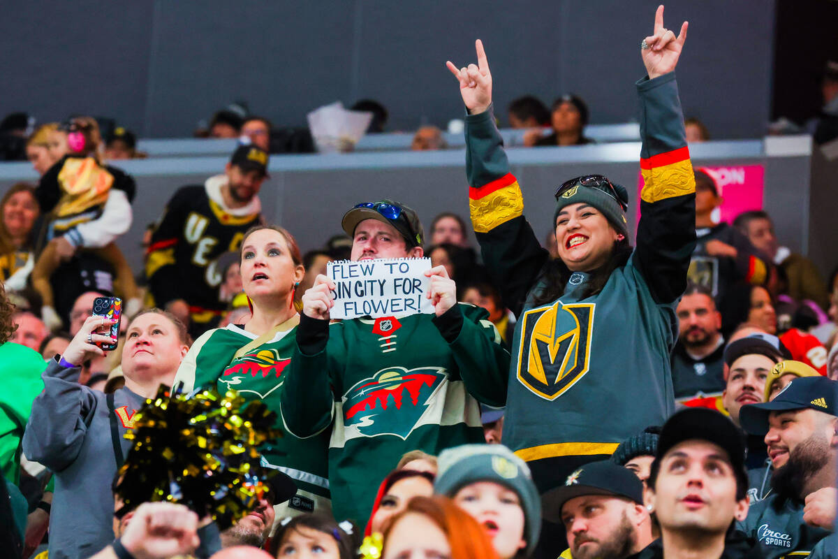 Fans cheer during an NHL hockey game between the Golden Knights and Minnesota Wild at T-Mobile ...