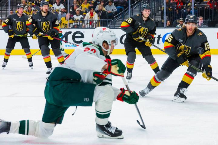 Golden Knights defenseman Noah Hanifin (15) eyes the puck during an NHL hockey game between the ...