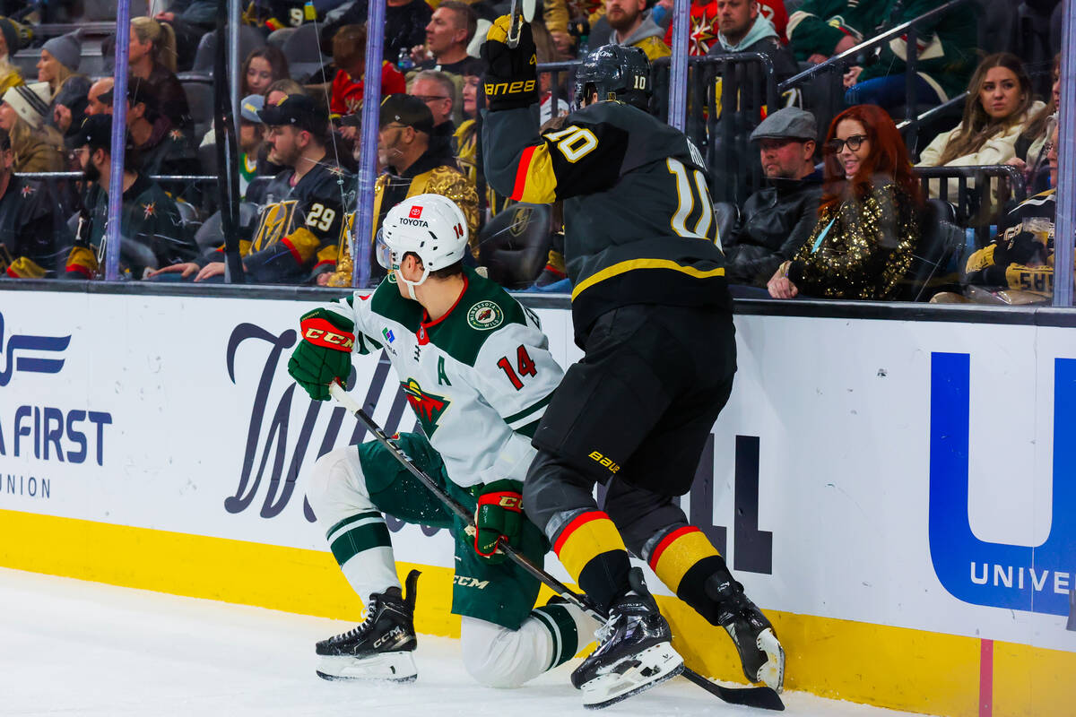 Golden Knights center Nicolas Roy (10) and Minnesota Wild center Joel Eriksson Ek (14) try to t ...