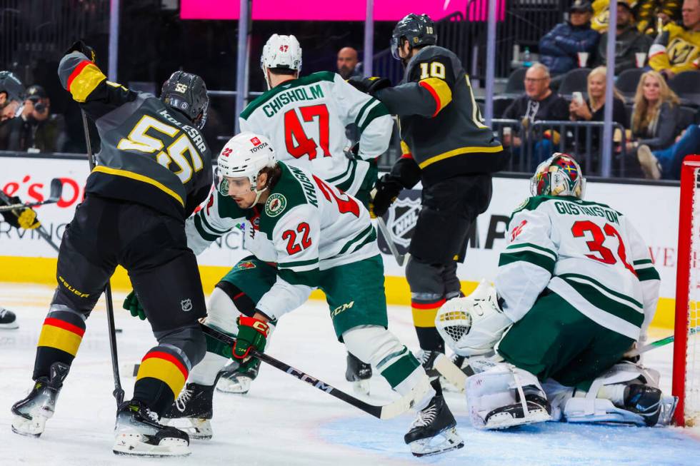 Golden Knights right wing Keegan Kolesar (55) watches the puck draw near as Minnesota Wild cent ...