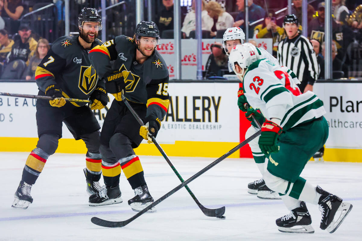 Golden Knights defenseman Noah Hanifin (15) eyes the net as Minnesota Wild center Marco Rossi ( ...