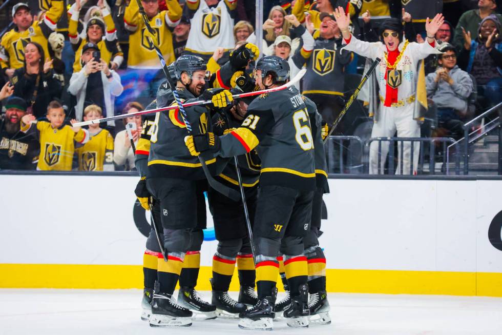 Golden Knights teammates celebrate a goal during an NHL hockey game between the Golden Knights ...