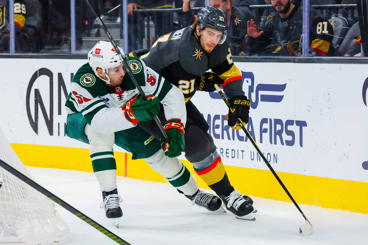 Golden Knights center Brett Howden (21) rounds the net with the puck during an NHL hockey game ...