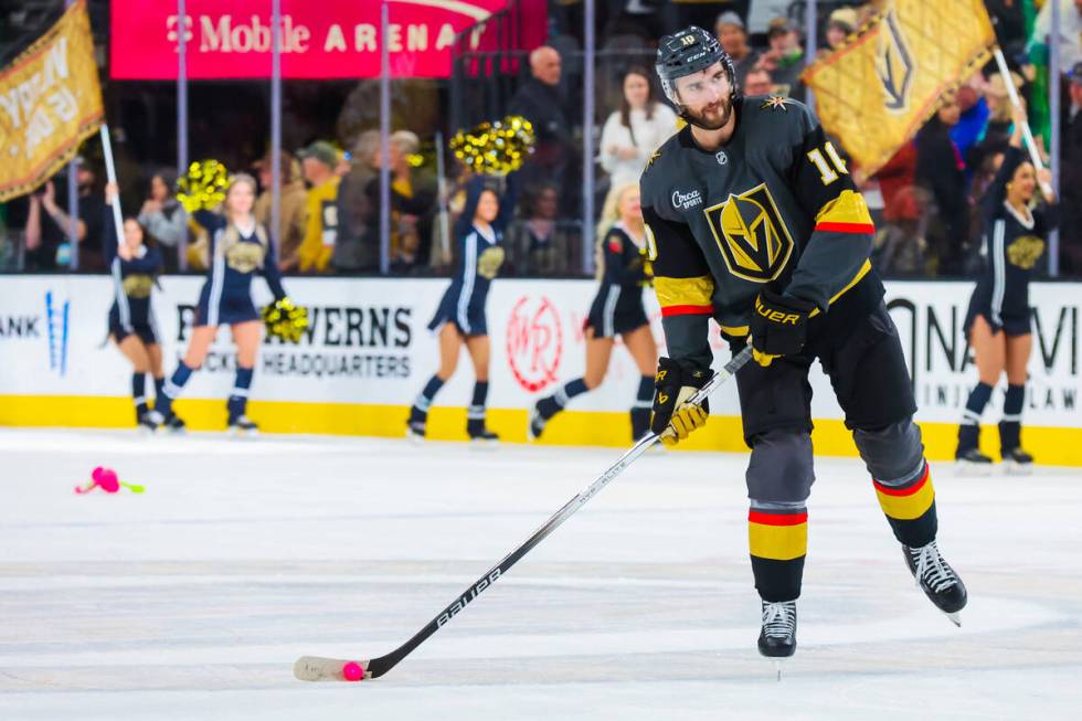 Golden Knights center Nicolas Roy (10) hits a mini flamingo figure with his puck following a 4- ...