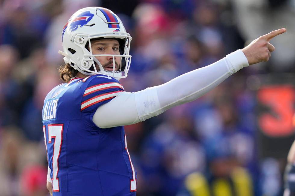 Buffalo Bills quarterback Josh Allen (17) motions for a first down during the first quarter of ...