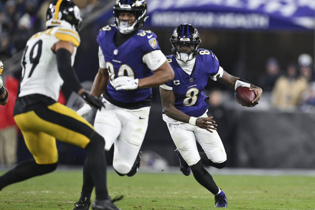 Baltimore Ravens quarterback Lamar Jackson (8) runs the ball during the second half of an NFL w ...