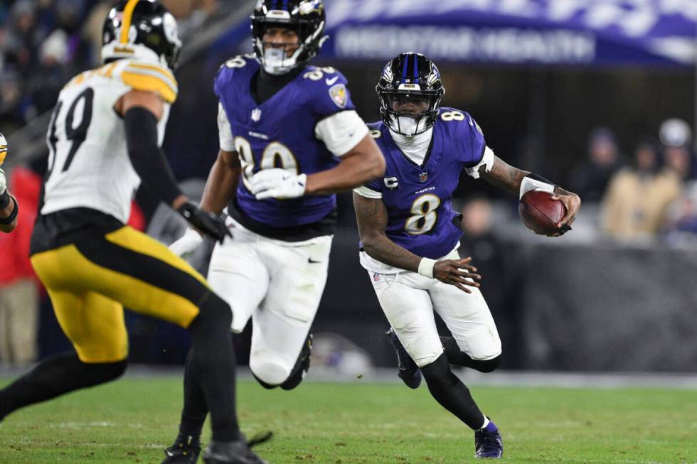 Baltimore Ravens quarterback Lamar Jackson (8) runs the ball during the second half of an NFL w ...