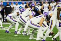 Minnesota Vikings quarterback Sam Darnold (14) gets set to run a play against the Detroit Lions ...