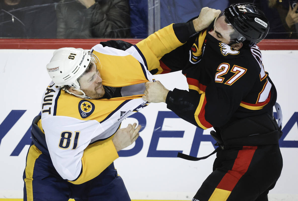 Nashville Predators' Jonathan Marchessault, left, fights with Calgary Flames' Matthew Coronato ...