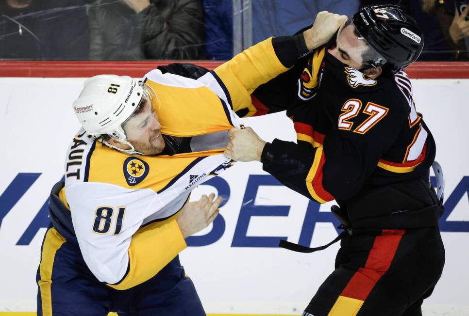 Nashville Predators' Jonathan Marchessault, left, fights with Calgary Flames' Matthew Coronato ...