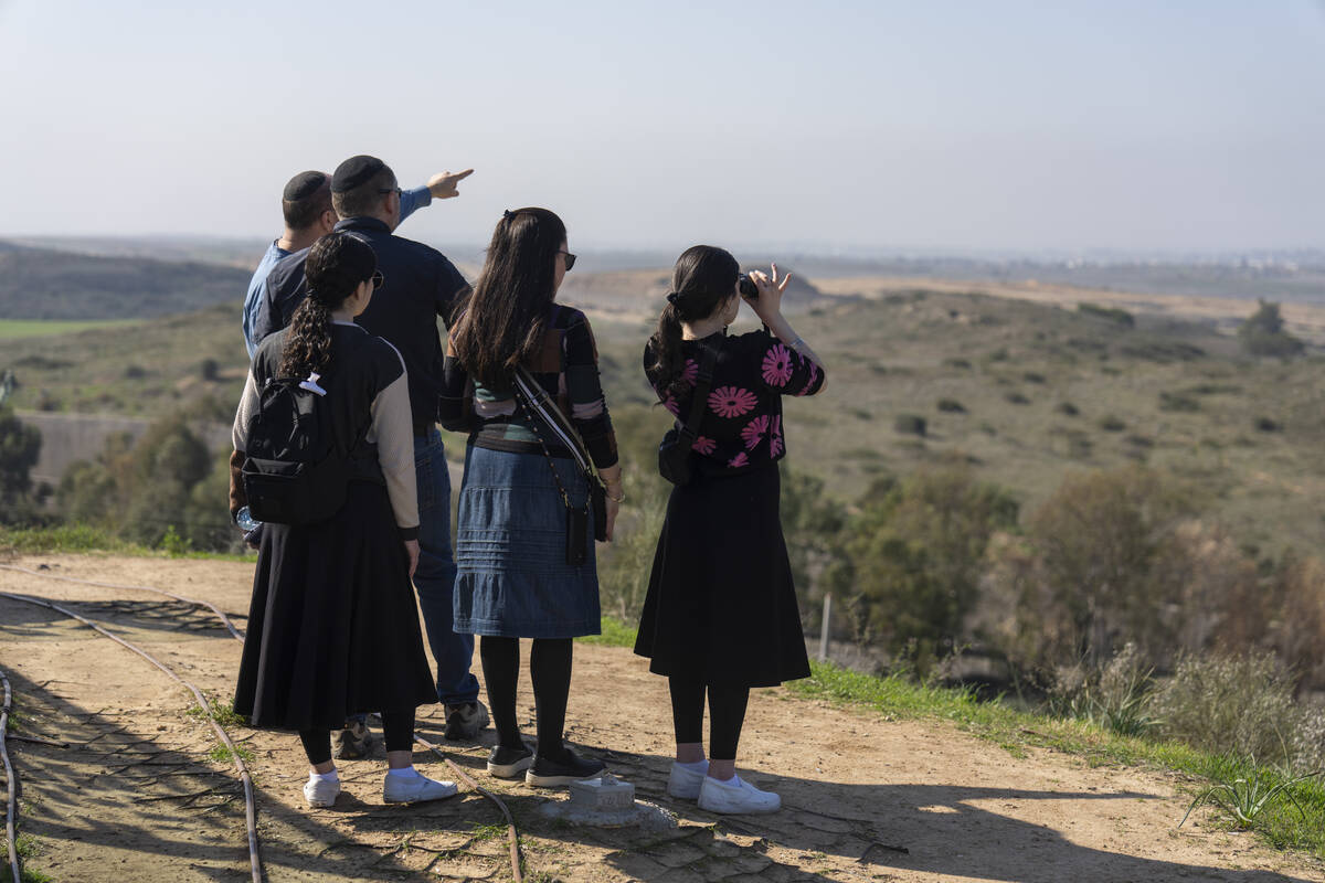 People watch the Gaza Strip from an observation point in Sderot, southern Israel, Monday, Jan. ...