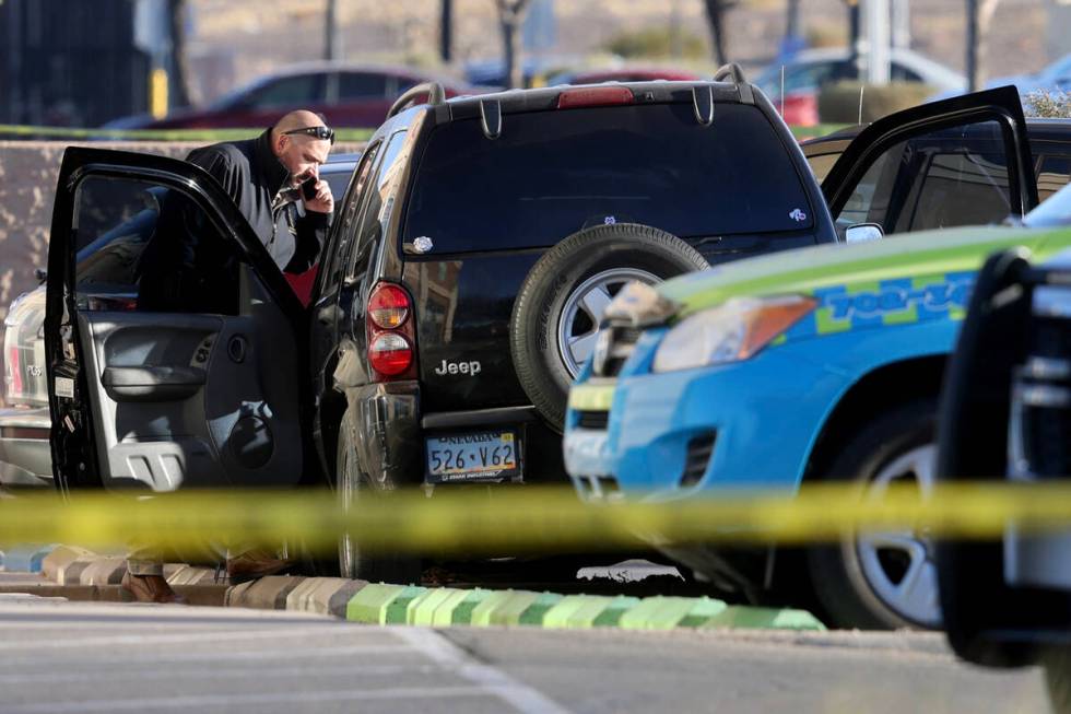 Henderson Police investigate the scene of an officer involved shooting that injured an officer ...