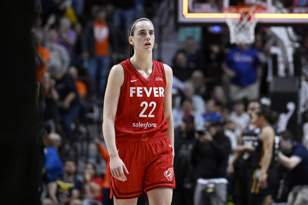 FILE - Indiana Fever guard Caitlin Clark (22) walks off the court after the Fever were eliminat ...