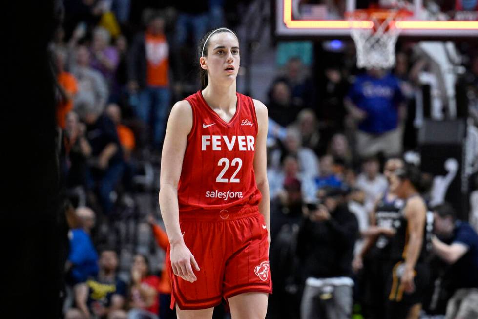 FILE - Indiana Fever guard Caitlin Clark (22) walks off the court after the Fever were eliminat ...