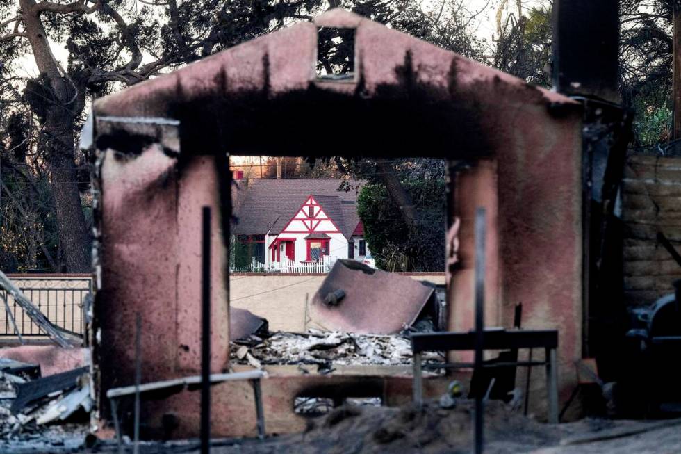 FILE - A home destroyed by the Eaton Fire stands in front of a home that survived in Altadena. ...