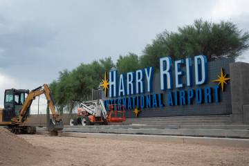 Construction crews work on new Harry Reid International Airport signage, Thursday, July 18, 202 ...