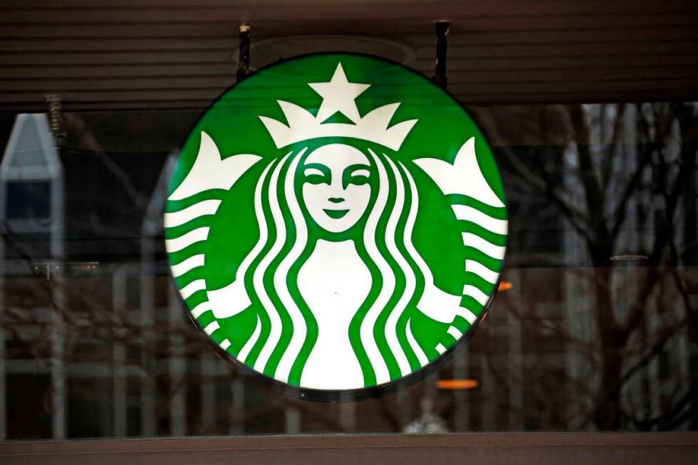 FILE - A Starbucks logo sign in the window of one of the chain's cafes in Pittsburgh, Jan. 12, ...