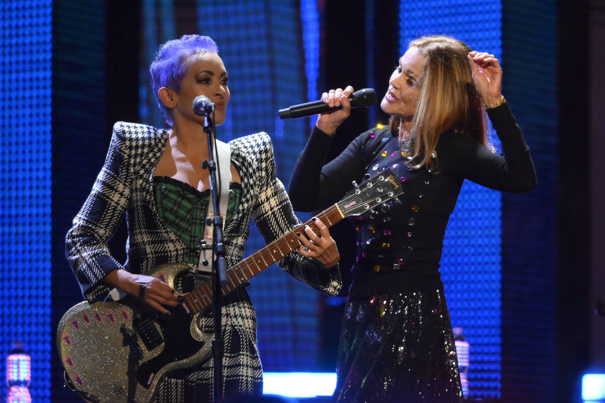 Jane Wiedlin, left, and Belinda Carlisle of the Go-Go's perform during the Rock & Roll Hall of ...